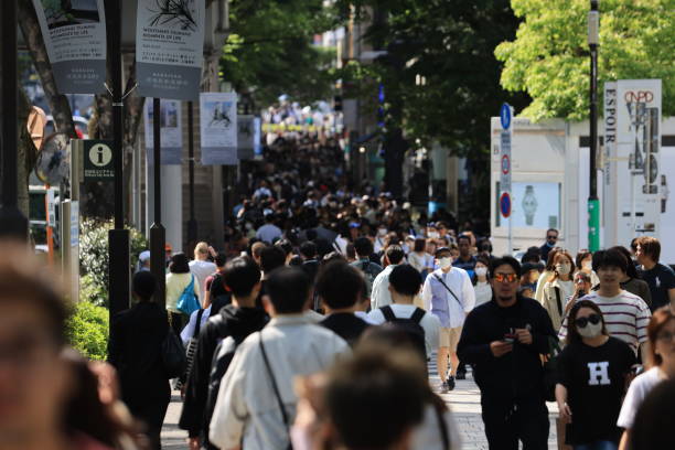 Tokyo - February 5 2023: crowded street in Omotesando. it is a zelkova tree-lined avenue located in Shibuya and Minato, Tokyo