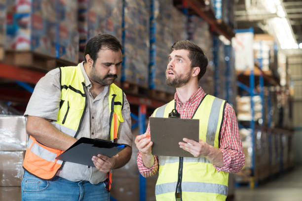 istock Warehouse concept. Two male warehouse worker working and checking boxes of products on shelf in warehouse. Group of two male worker at warehouse 2170772083