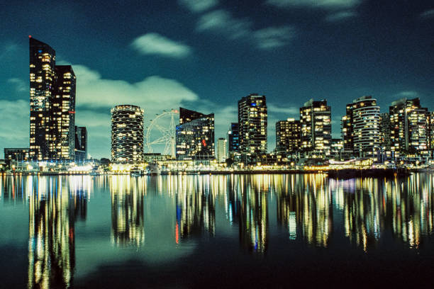 Melbourne Docklands at Night – Captured on a Nikon FM 35mm Film Camera, showcasing the dazzling reflections of the skyline on the Yarra River.