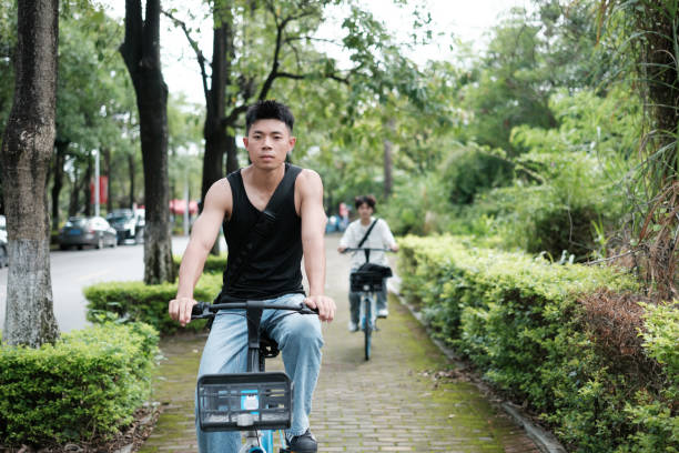 Asian college students go to class on bicycles