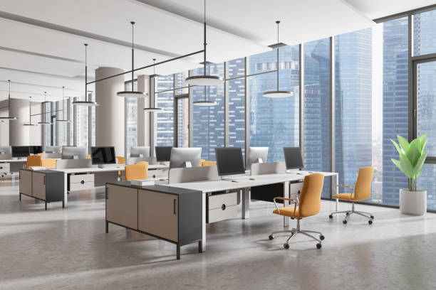 istock Stylish office workplace interior with pc monitors in row, panoramic window 2170781724