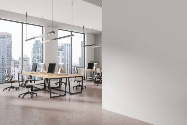 istock Office coworking interior with pc monitors in row, panoramic window 2170783123