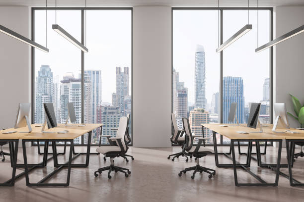 istock Office coworking interior with pc monitors in row, panoramic window 2170783131