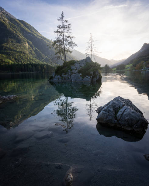 istock Vertical, landscape scenery with isolated rocks and tree on a surface of alpine lake during sunset 2170784390
