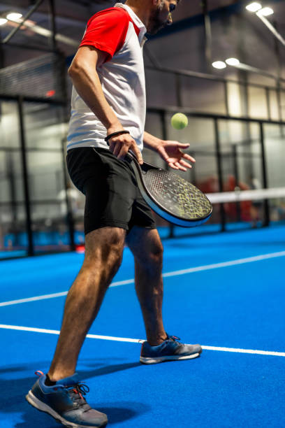 istock Mature man serving while playing paddle tennis 2170786477