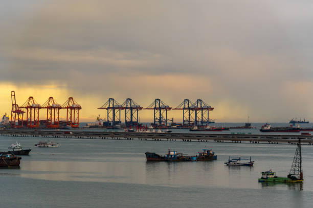 istock Logistic shipping quay boat in twilight sky night Engineering crane depot at logistic export terminal control. Warehouse freight background container yard loading quayside harbor port Logistics. 2170786544