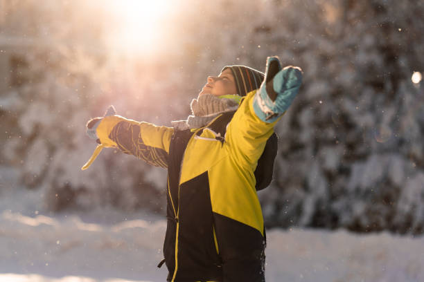 istock Boy whit outstretched arms standing on a snowy mountain 2170788998