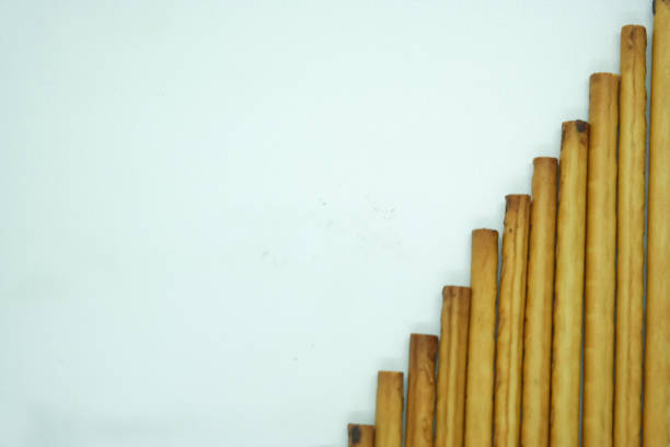 Close-up of several chocolate sticks arranged diagonally on a white background