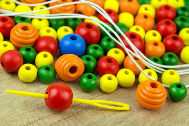 Colorful wooden craft beads and needle