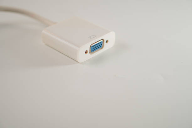 Close-up of a VGA connector with a white casing on a light background.