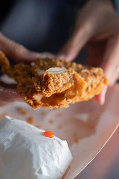 istock Close-Up of Crispy Fried Chicken in Hands 2170795044