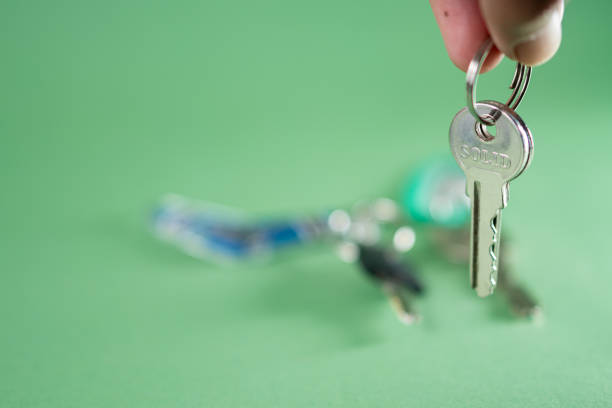 A metallic bunch of shiny car keys isolated on a white background