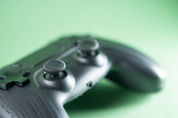 istock Close-Up of Black Gaming Controller on Green Background 2170795705