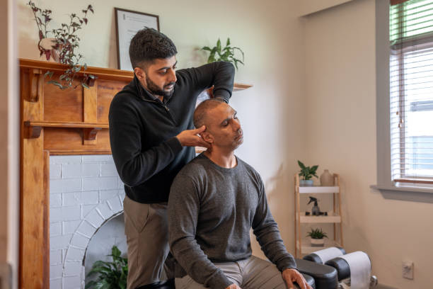 Male Patient Receiving Neck and Spine Examination A young male chiropracter assessing patient's neck and spinal alignment chiropractors stock pictures, royalty-free photos & images