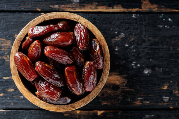 istock Dried Dates in Wooden Bowl on Dark Rustic Background, Copy Space 2170801057