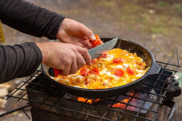 istock A man slices tomatoes in order to fry them with eggs 2170802734