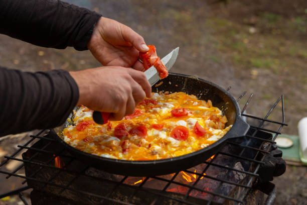 istock A man slices tomatoes in order to fry them with eggs 2170802745