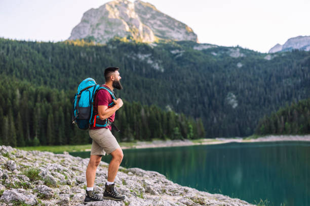 istock Man Hiking by a Mountain Lake with Scenic View 2170802951