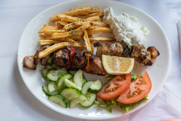 Pork souvlaki with potatoes and salad in Greece