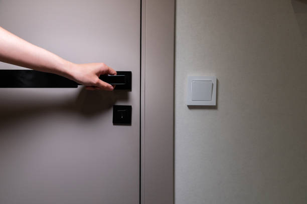 istock A woman's hand opens the door to the room. Copy space 2170804097