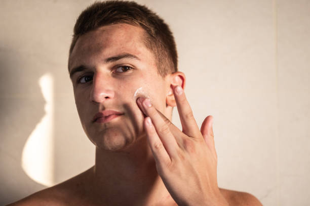 istock Young Man Putting On Face Cream 2170804137
