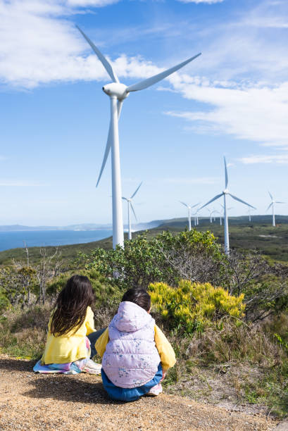 istock two young girls watching by Wind Turbines 2170804262