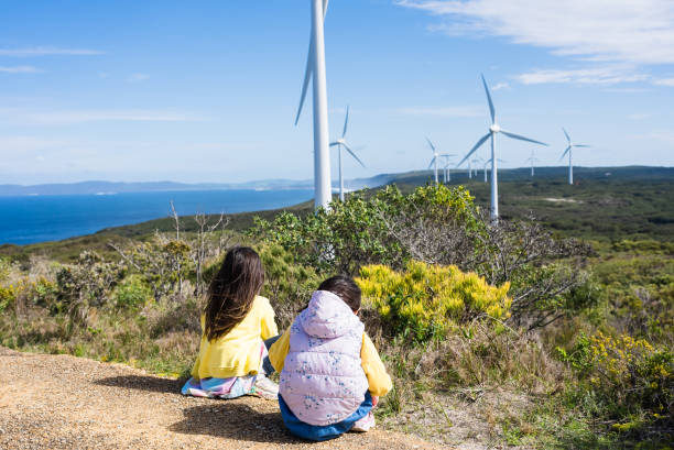 istock two young girls watching by Wind Turbines 2170804265