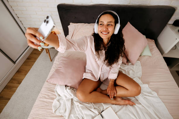 istock Woman takes a selfie on the bed 2170804964