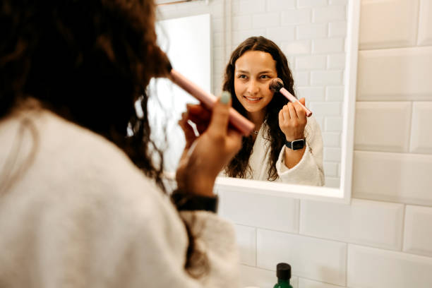 istock Young woman applying make up in the morning 2170805007