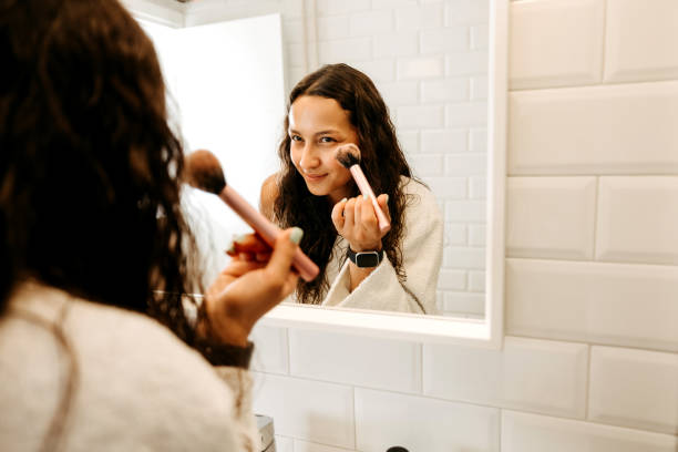 istock Young woman applying make up in the morning 2170805009