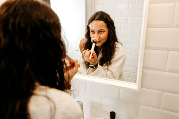 istock Young woman applying make up in the morning 2170805017