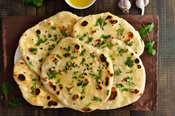 istock Indian naan bread over wooden background 2170806268