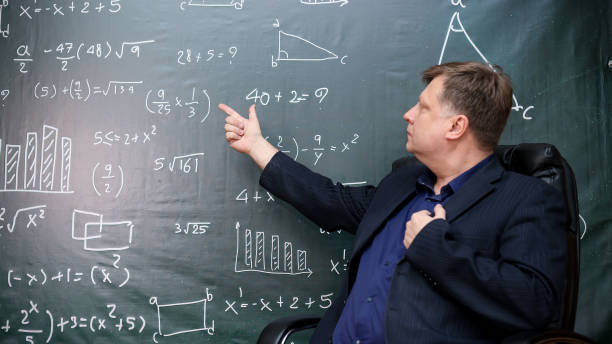 istock An adult teacher at the blackboard explains a task in higher mathematics 2170806976