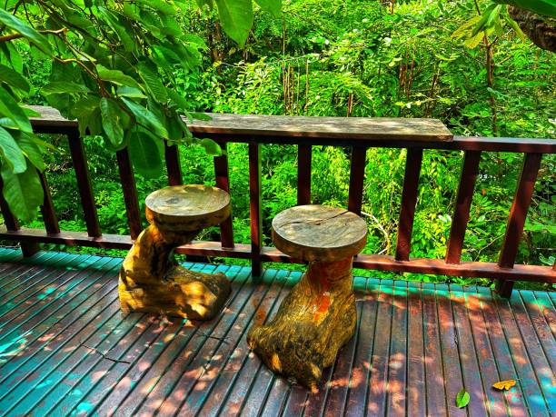 Rustic outdoor tree stump bench on the green in the park