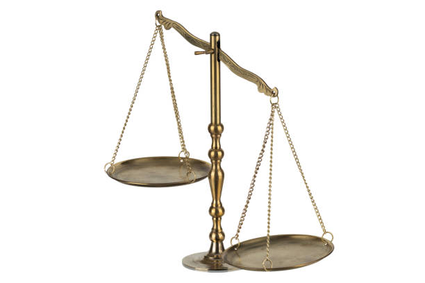 Bronze traditional balance scale with weights isolated on white background.