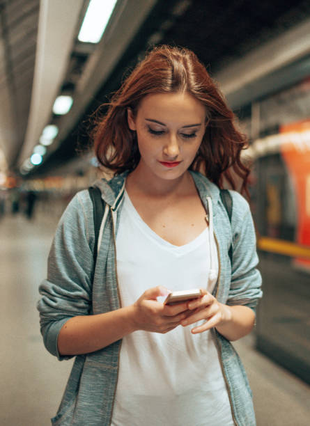 istock young woman using social media waiting the metro train 2170815106