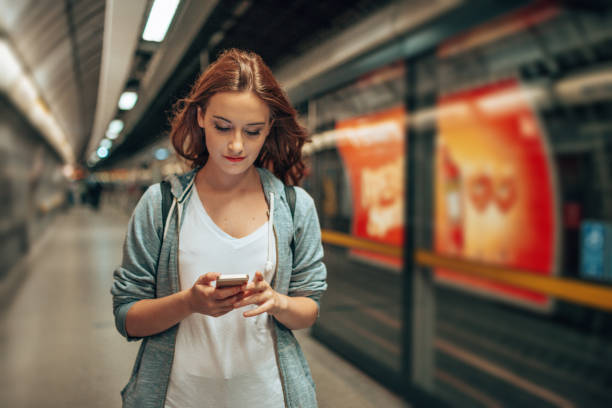 istock young woman using social media waiting the metro train 2170815155
