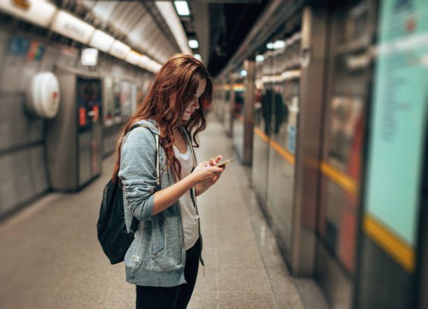 istock young woman using social media waiting the metro train 2170815222