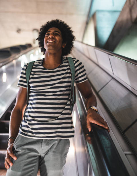 istock afro man on the escalator at the station 2170817098
