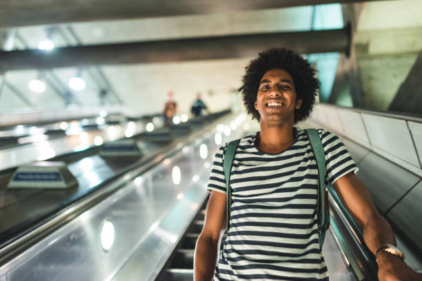 istock afro man on the escalator at the station 2170817114