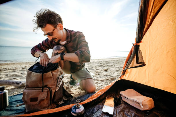 istock Man cooking coffee at sea sandy beach. 2170817132