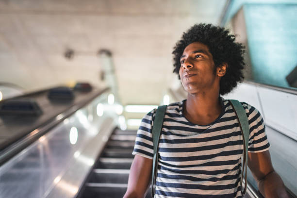 istock afro man on the escalator at the station 2170817133