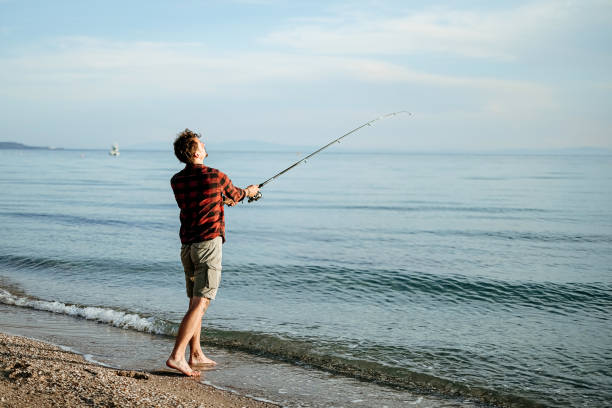 istock Man is fishing from the shore 2170817263
