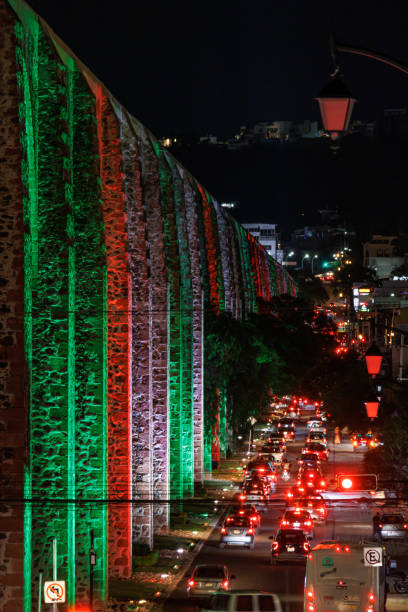 Aqueduct arches illuminated with Mexican patriotic colors