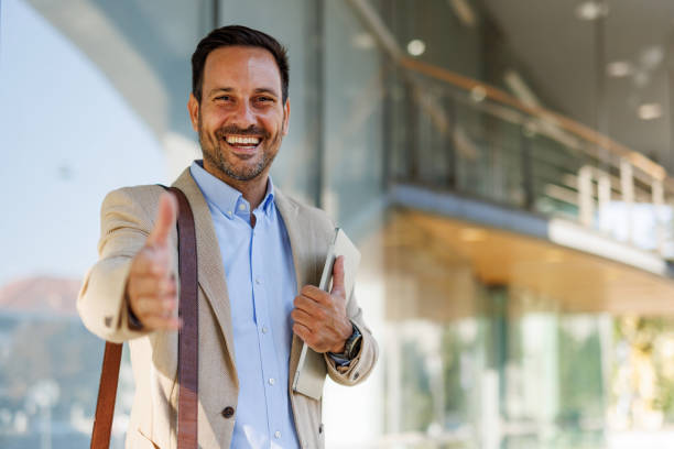 istock Man smiling and offering handshake near modern office 2170817959