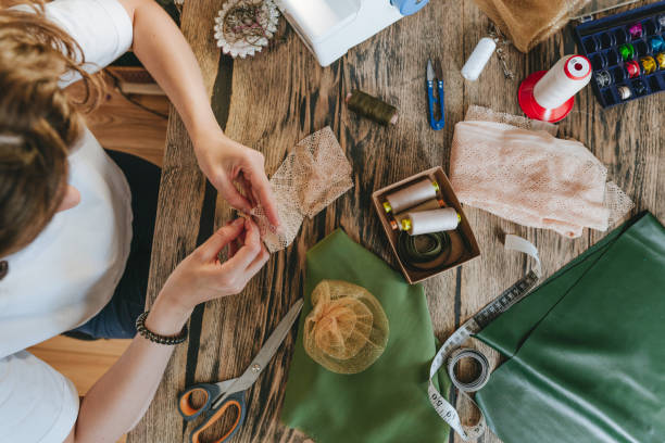 istock Top view of female tailor sewing sitting at the table making handmade decor 2170820308