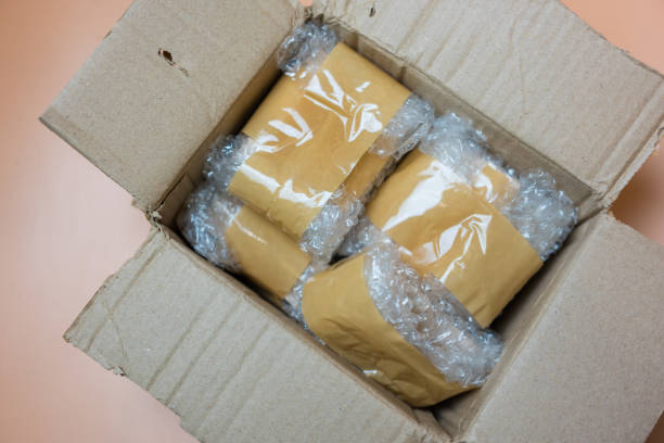 istock Package wrapped in white bubble pack and adhesive tape in brown box. 2170821521
