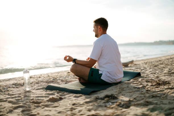 istock Man on the beach doing yoga 2170823243