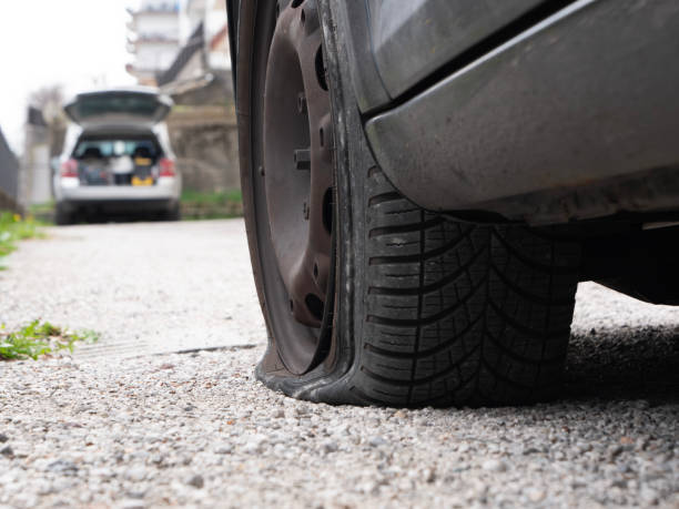 istock flat tire car damage insurance 2170826024