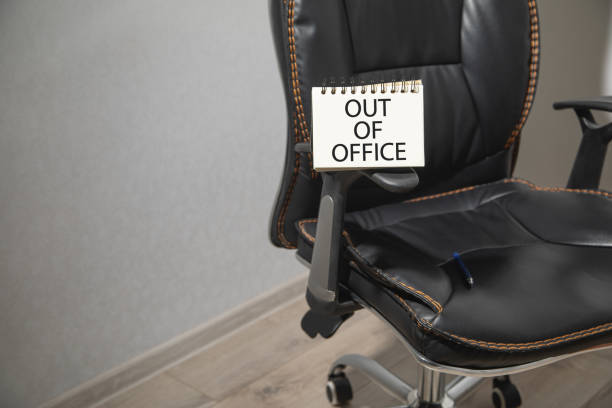 istock Out Of Office message on notepad with a office chair. 2170826302